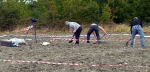 a_Archaeologists_clearing_loose_plough_soil_03